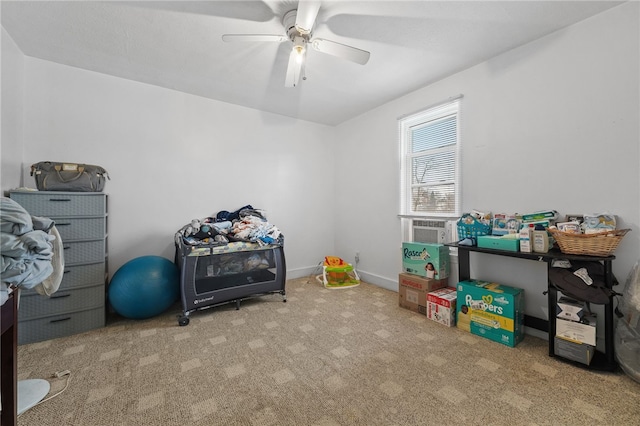 game room featuring light carpet and ceiling fan