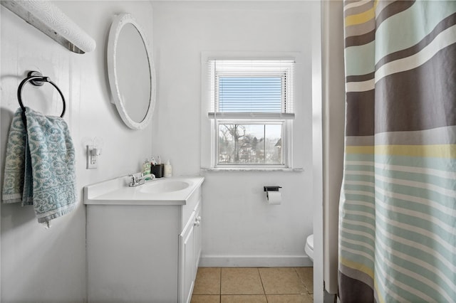 bathroom featuring toilet, vanity, and tile patterned flooring