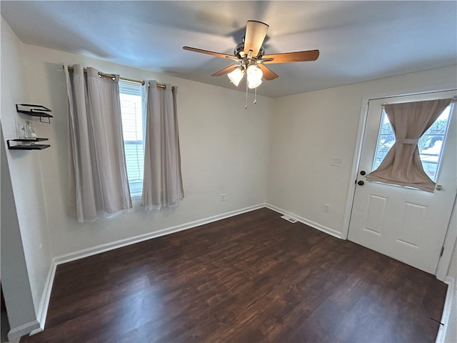 entrance foyer featuring ceiling fan and dark wood-type flooring