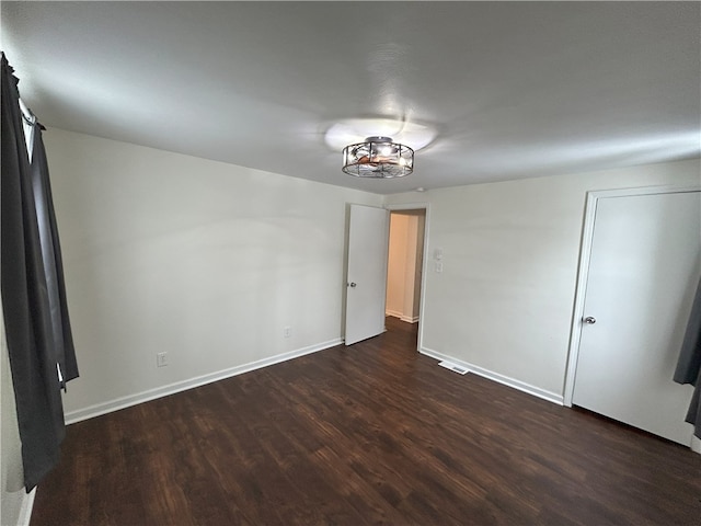 empty room with dark wood-type flooring