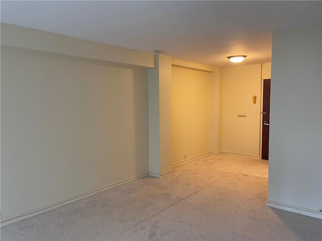 basement featuring light carpet