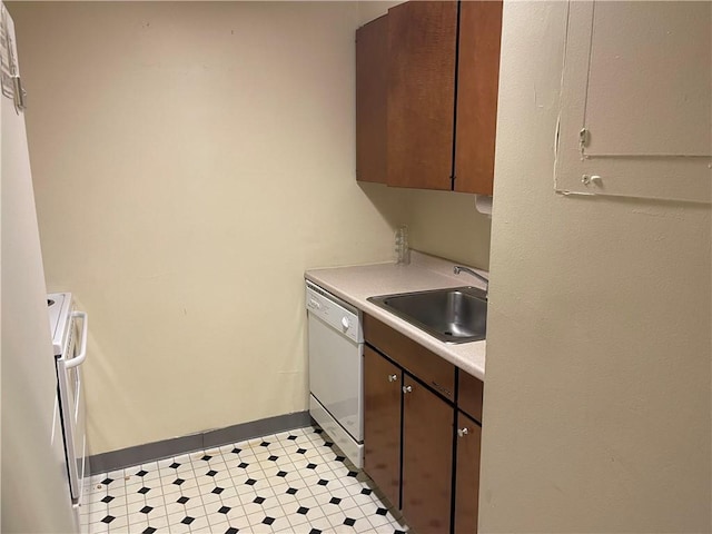 kitchen with stove, dishwasher, sink, and dark brown cabinets