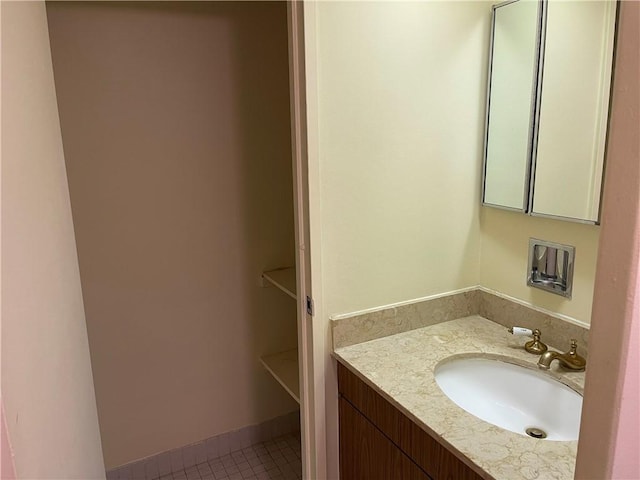 bathroom featuring tile patterned flooring and vanity