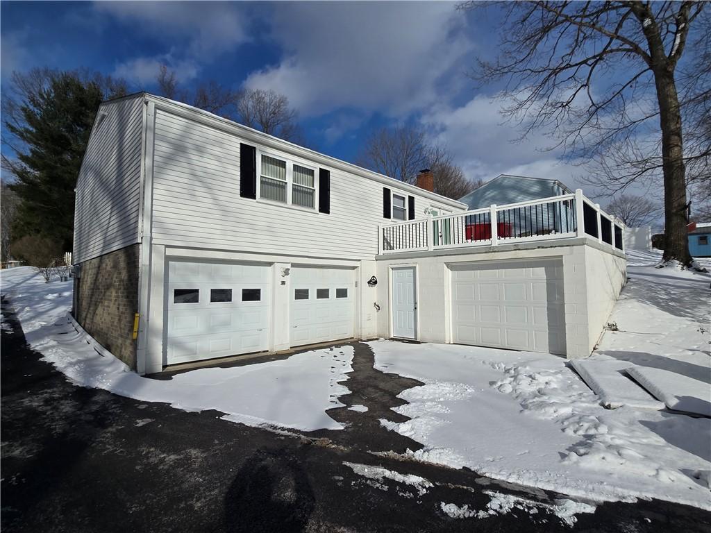 view of front of home featuring a balcony and a garage