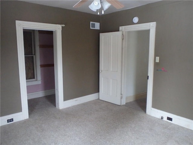 unfurnished bedroom with ceiling fan, a closet, and light carpet