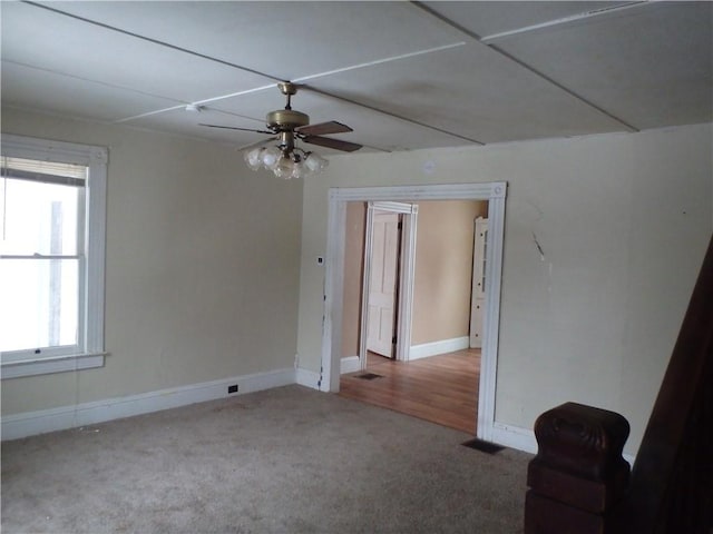 empty room with carpet floors and ceiling fan