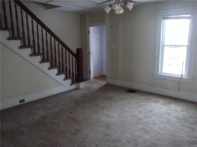 interior space featuring ceiling fan, carpet flooring, and plenty of natural light