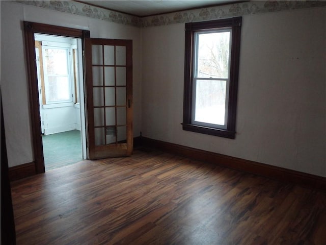 unfurnished room featuring dark hardwood / wood-style floors and french doors