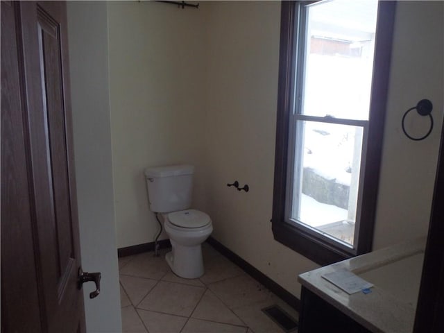 bathroom with toilet and tile patterned floors