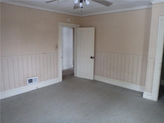 spare room with ceiling fan and concrete flooring