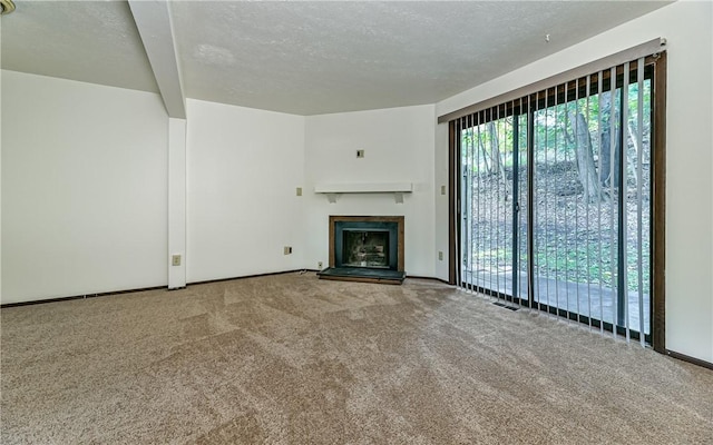 unfurnished living room featuring a textured ceiling and carpet flooring