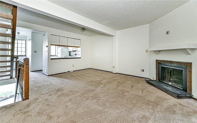 unfurnished living room with light carpet