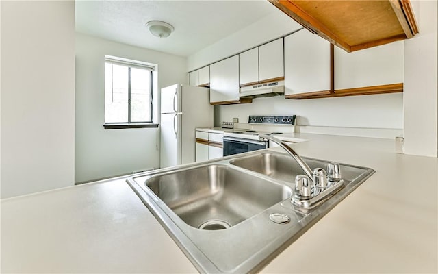 kitchen with sink, white appliances, and white cabinetry