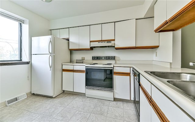 kitchen featuring white cabinetry, sink, and white appliances