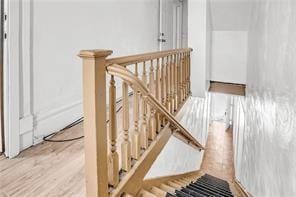 stairs with hardwood / wood-style flooring