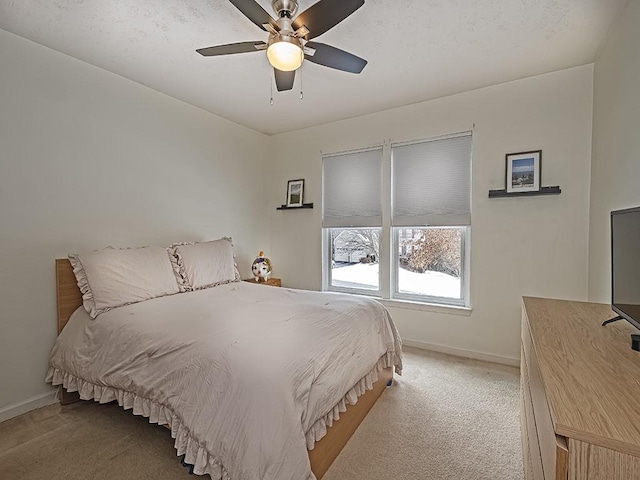 bedroom with light carpet and ceiling fan