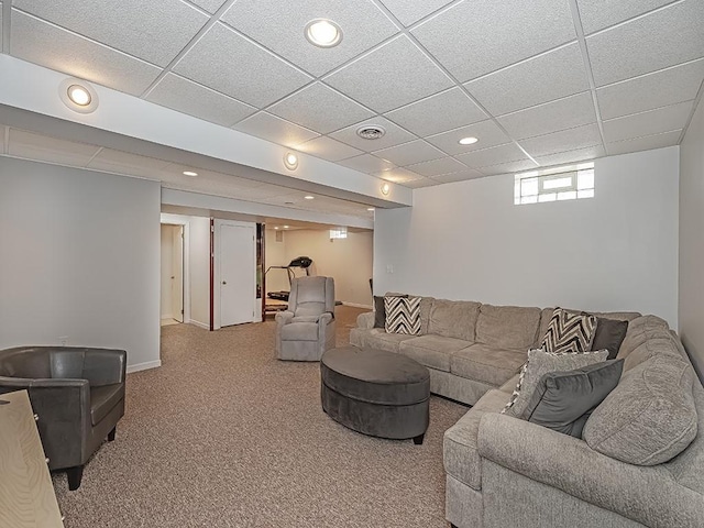 living room with carpet and a paneled ceiling