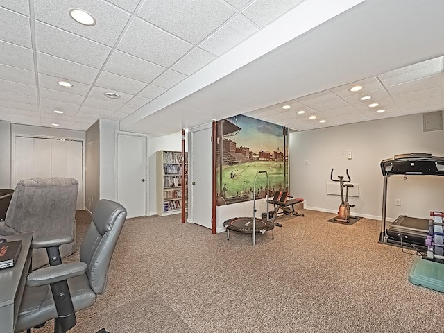 interior space with carpet floors and a paneled ceiling