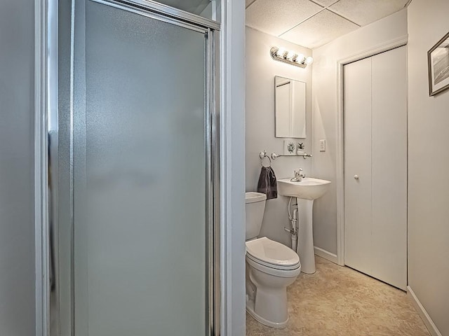 bathroom featuring toilet and a shower with shower door