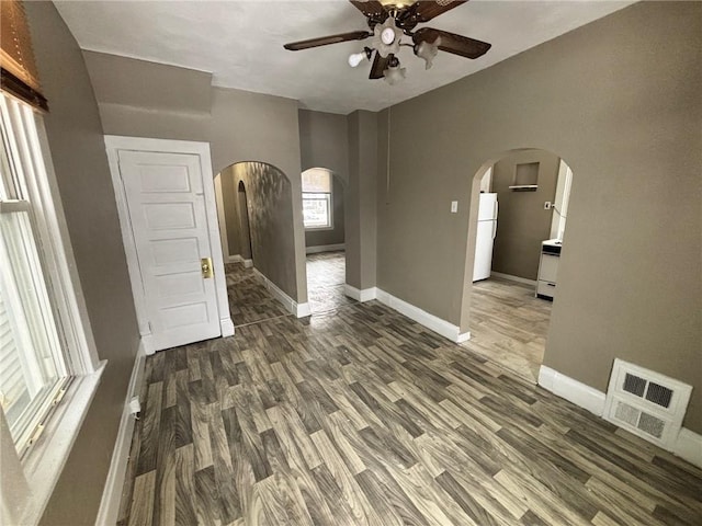 empty room featuring ceiling fan and dark hardwood / wood-style floors