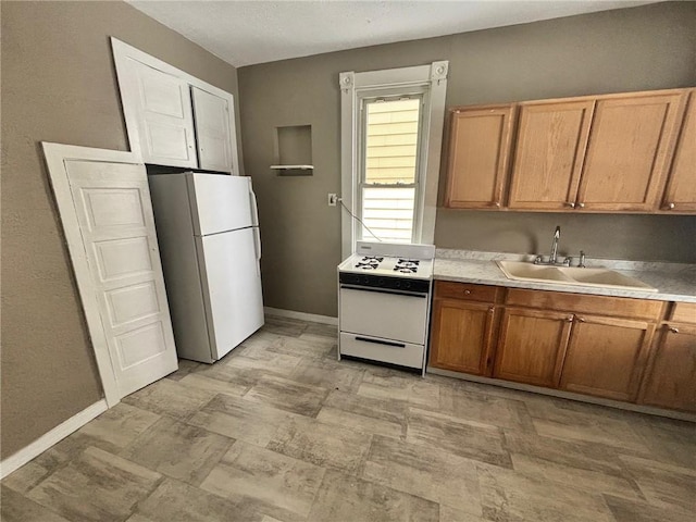 kitchen featuring sink and white appliances