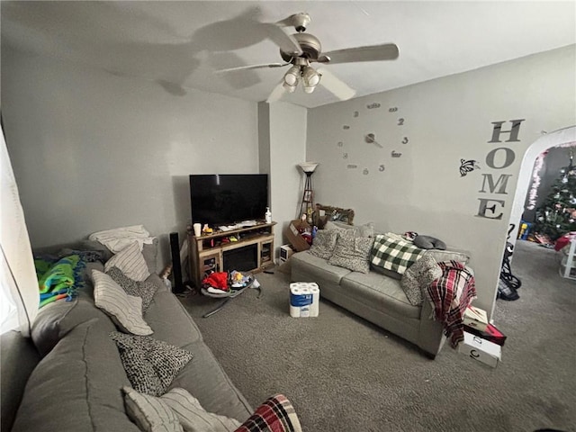 living room featuring ceiling fan and carpet