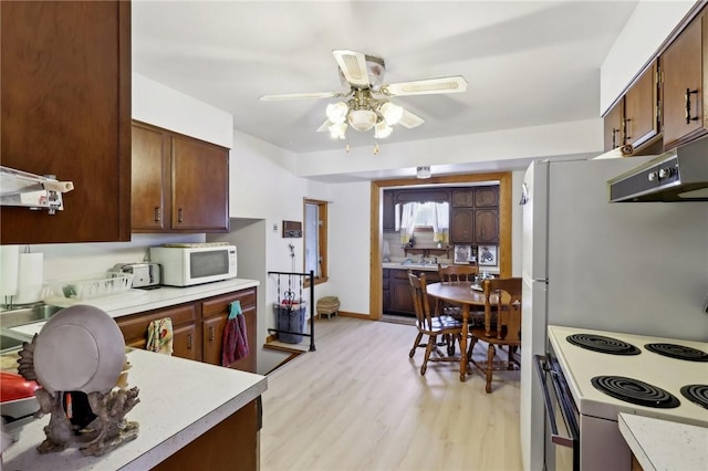 kitchen featuring ceiling fan, white appliances, and light wood-type flooring