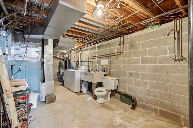 basement with separate washer and dryer, sink, and water heater