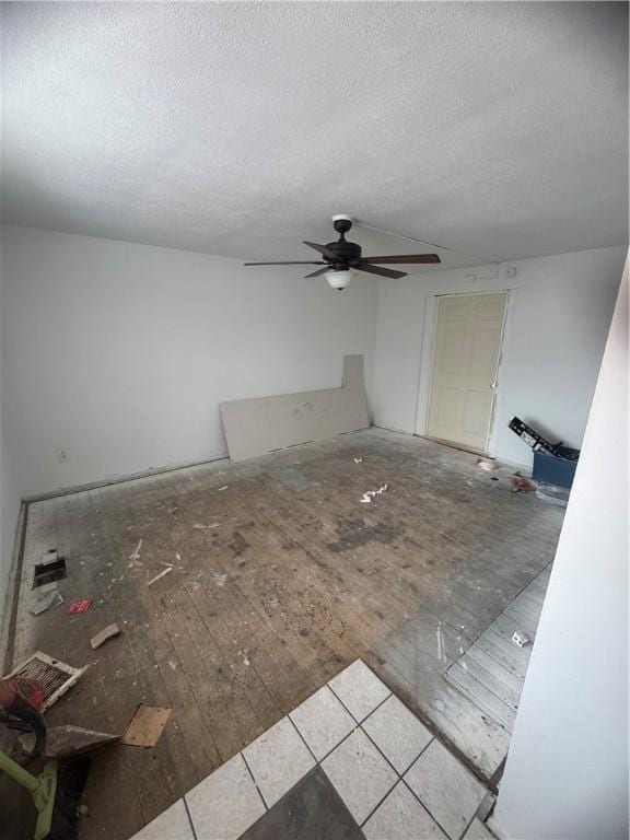 interior space featuring ceiling fan and a textured ceiling