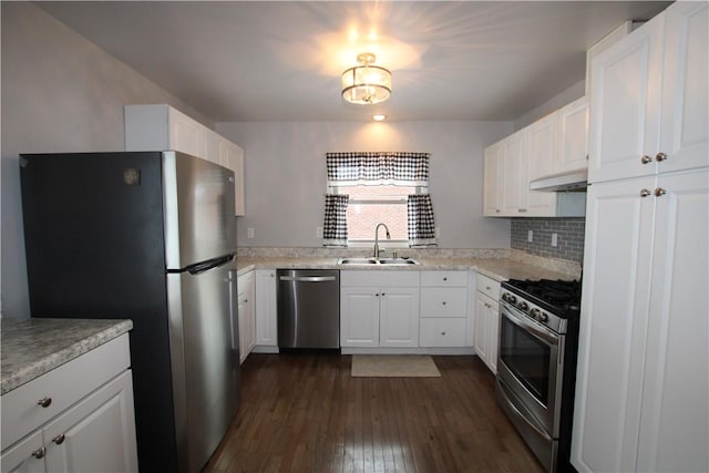 kitchen featuring decorative backsplash, sink, stainless steel appliances, and white cabinetry