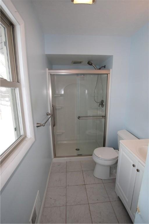 bathroom with an enclosed shower, vanity, tile patterned floors, and toilet