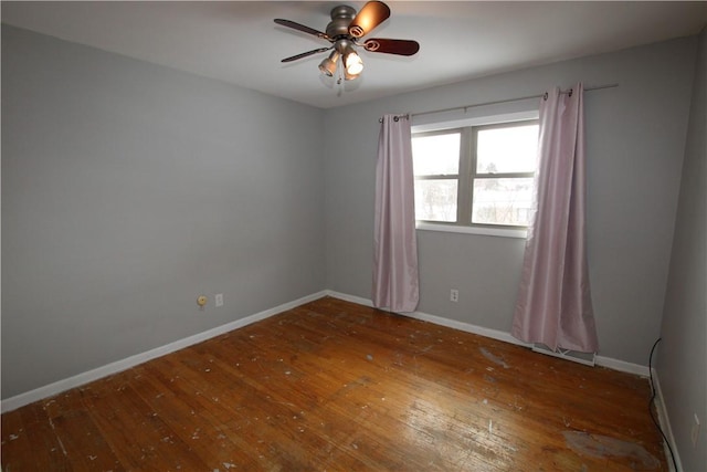 empty room with hardwood / wood-style flooring and ceiling fan