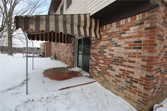 view of snow covered property entrance