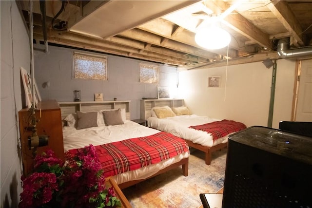 bedroom with ceiling fan and concrete flooring