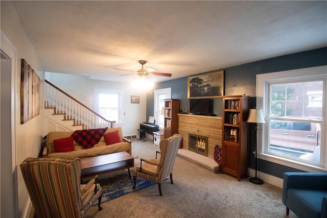 carpeted living room with ceiling fan and a wealth of natural light