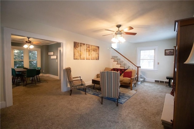 carpeted living room with ceiling fan