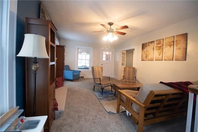 carpeted living room featuring ceiling fan