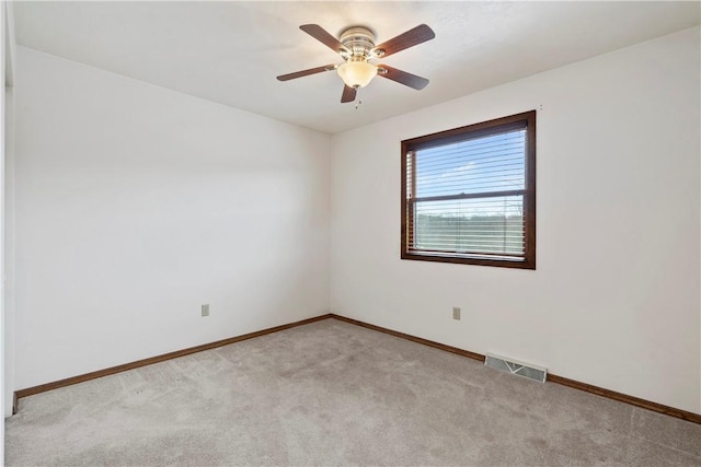 spare room featuring ceiling fan and light colored carpet