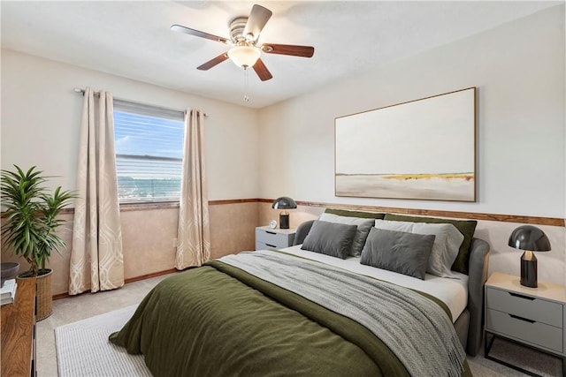 bedroom featuring ceiling fan and light carpet