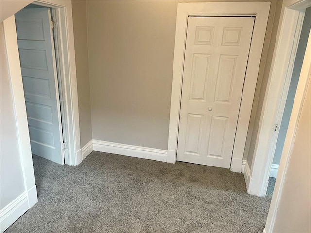 unfurnished bedroom featuring a closet and carpet flooring