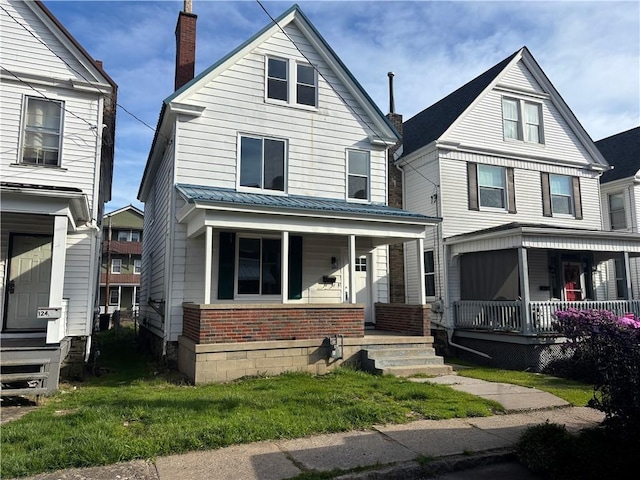 122 Rebecca St, Kittanning Boro, PA 16201 - view of front of house with a chimney, brick siding, a porch, and a front yard