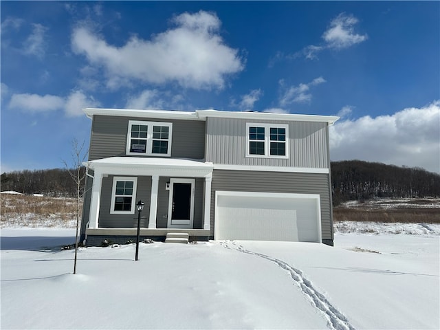 view of front of property with covered porch and a garage