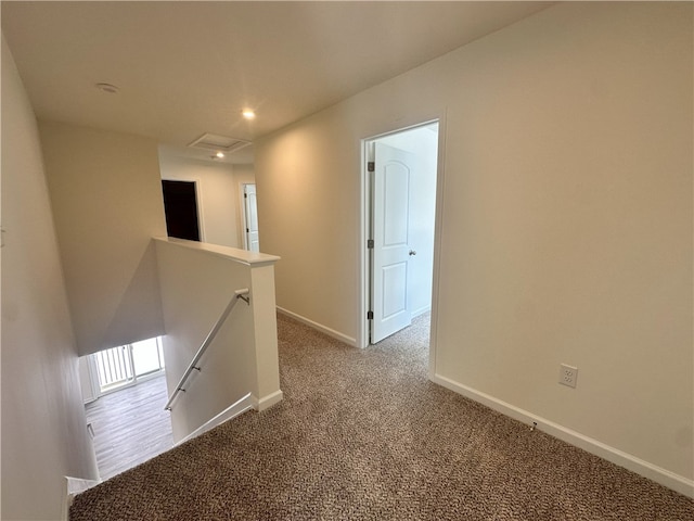 hallway featuring light colored carpet