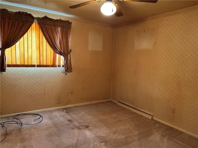 carpeted spare room featuring a baseboard heating unit and ceiling fan