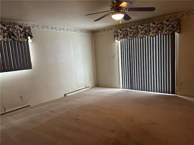 empty room with ceiling fan, carpet, and a baseboard heating unit