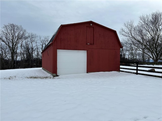 snow covered structure with a garage