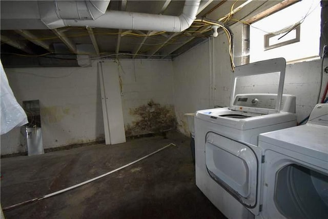 clothes washing area featuring separate washer and dryer