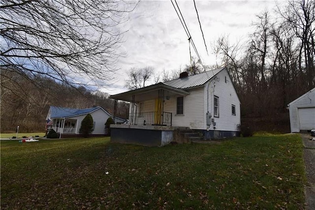 view of property exterior featuring a lawn and covered porch