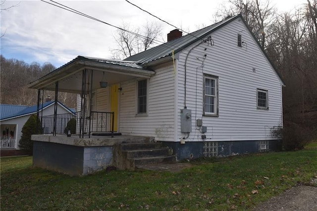 exterior space with covered porch and a lawn