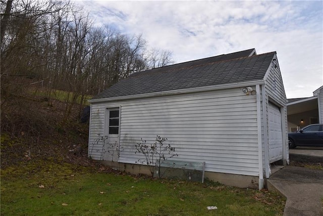 view of home's exterior featuring a garage and an outbuilding